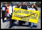 Residents carry the Martin Luther King Jr. banner as they march along FM 116
with members of Bible way Missionary Baptist Church Monday.